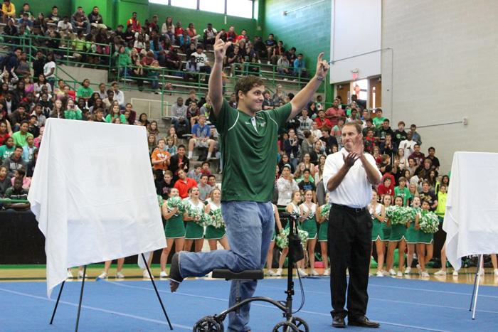 Luke Joeckel holds his horseshoes high as the crowd roars. Joeckels high school jersey, No. 72, was retired.