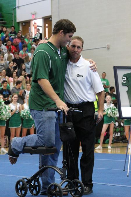 Luke Joeckel and head coach Scott Peach embrace during the jersey retirement ceremony. Peach coached Joeckel during his years at AHS and now Joeckel plays for the Jacksonville Jaguars.