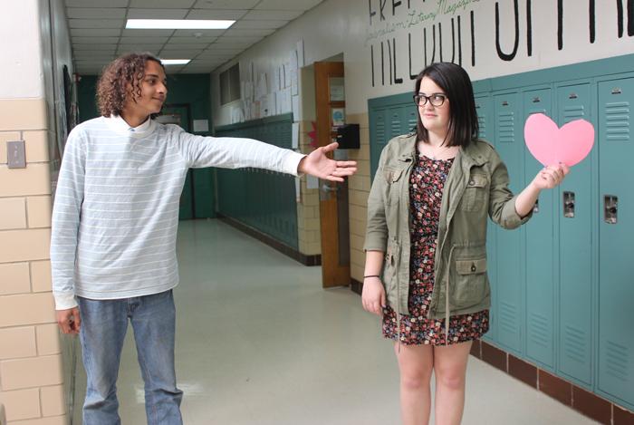 Senior Cassidy Walsh holds her heart just out of reach of senior Quentin Paramore. On Hush Day, students were instructed to share their hearts with the right person.