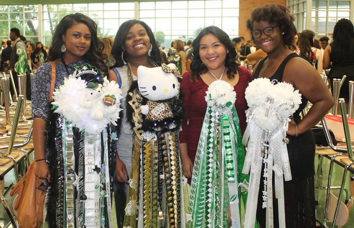 Students show off their mums during the Homecoming breakfast. Mums vary in size but many believe bigger is better.