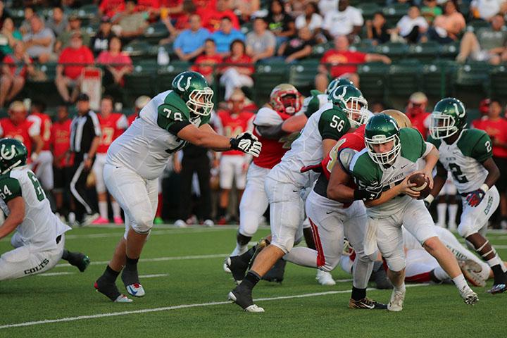 Senior Caelan Day ducks past the defensive line during the game against South Grand Prairie. As starting quarterback, Day brings a personal style of leadership to the field.