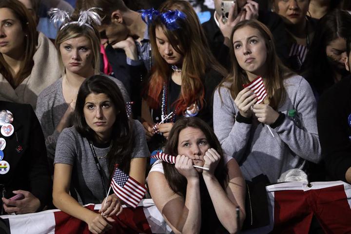 Supporters watch the election results on a large television monitor during Democratic presidential nominee Hillary Clintons election night rally Tuesday, Nov. 8, 2016.