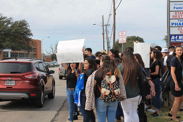 Students++walked+out+of+school+at+noon+to+protest+Trumps+immigration+laws+and+the+racism+many+of+them+encounter+on+campus+every+day.+They+held+up+posters%2C+chanted+and+made+their+way+down+Park+Row%2C+cheering+when+drivers+honked+in+solidarity.