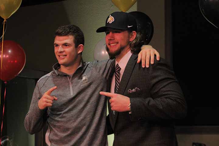 Seniors Caleb McKee and Nic Foster congratulate each other on National Signing Day. McKee committed to WestPoint and Foster committed to Texas State.