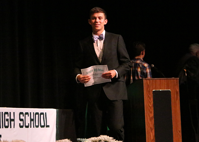 Senior Nathan Vasquez accepts one of nine scholarships he received.  He will be attending UT in the fall to major in petroleum engineering.