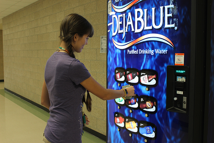 Looking for a caffeine kick, junior Isabella Rodriguez stops by the new soda vending machine. The machines were brought back to campus to curb students leaving school to get snacks.