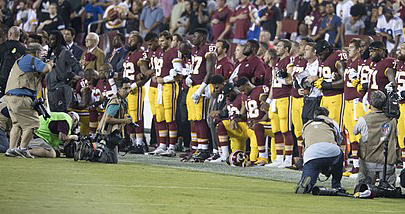 Members of the Washington Redskins kneel during the national anthem before facing the Oakland Raiders on September 24. To protest inequality in America, many NFL players took a knee during the playing of the national anthem at their end of September games. The protest on a national platform brought both praise and criticism.