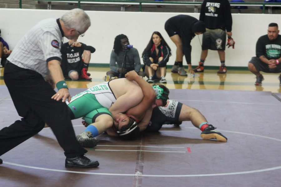 Senior Brandon Chapin attempts to pin his opponent during the first tournament of the season. Chapin is ranked 14th in the state in his weight class.