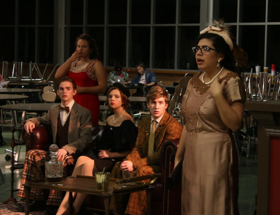 Mrs. Peacock, played by senior Gloria Adame, reacts to shocking news while the rest of the characters look on.